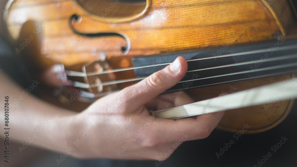 close up of a person playing a violin close up of a person playing a violin