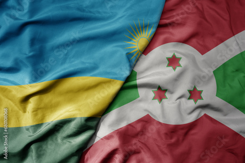 big waving national colorful flag of burundi and national flag of rwanda .