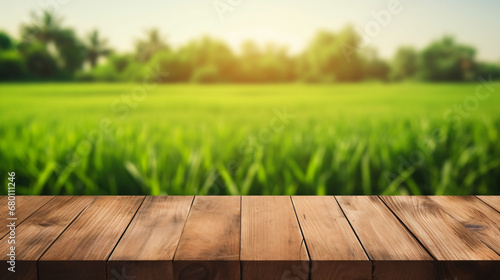 Wood table on blurred background of green rice