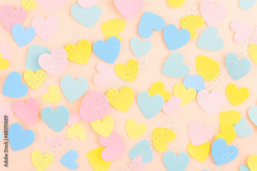 Colorful pastel paper hearts pattern on pastel background