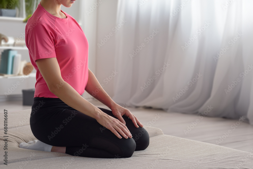 Calm healthy woman exercising at home, in a special place for home workouts, close-up photo