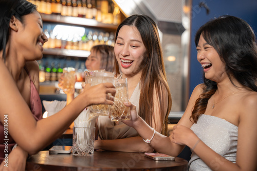 Beautiful Asian Woman Enjoying with Friend in Bar. They Enjoying with Night Party Together. Party, Lifestyle, Happiness, Cheerful and Celebration Concept. 