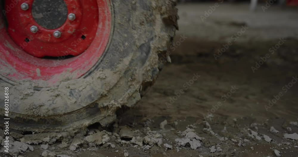Muddy Tractor Tire Wheel closeup view driving off frame in slow motion cinematic Muddy Tractor Tire Wheel closeup view driving off frame in slow motion cinematic