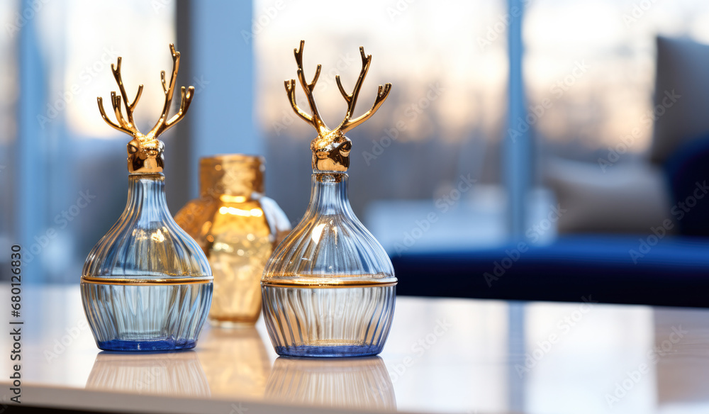 Two glass vases with deer heads sitting on top of a table. Two glass vases with deer heads sitting on top of a table.