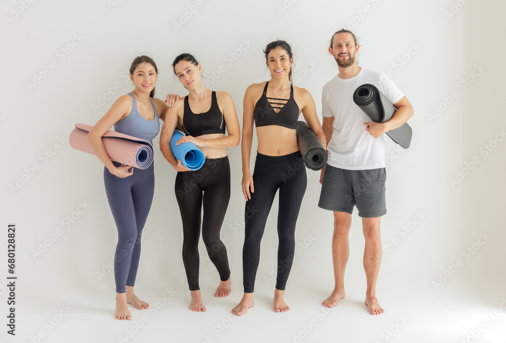 Diverse Yoga Enthusiasts with Mats Ready for a Group Class Diverse Yoga Enthusiasts with Mats Ready for a Group Class