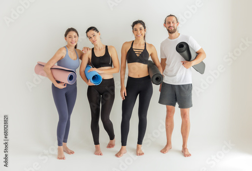 Diverse Yoga Enthusiasts with Mats Ready for a Group Class