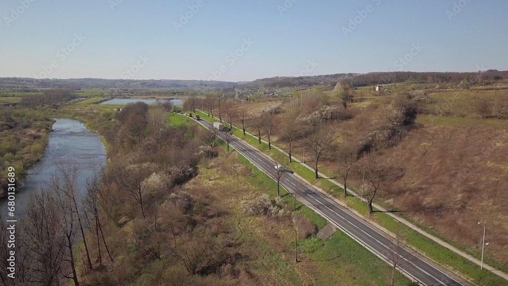 Panorama of road from a bird's eye view. Central Europe:  town or village is located among the green hills. Temperate climate. Flight drones or quadrocopter.