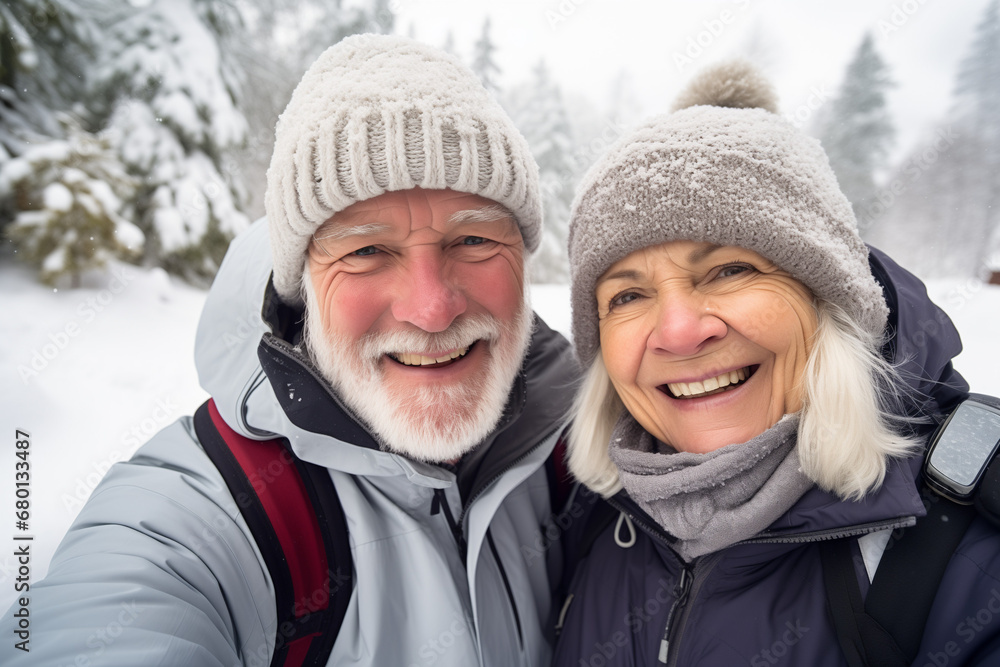 Elderly couple embracing the joy of an active winter getaway in a picturesque snowy landscape, National Grandparents Day, International Day of Older Persons