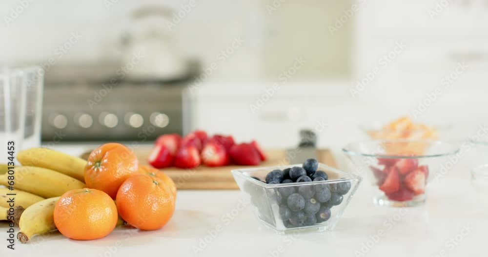 Delicious colourful fruits lying on white counter in sunny kitchen Delicious colourful fruits lying on white counter in sunny kitchen