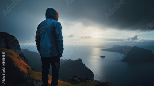 A person stands on the top of a mountain and looks into the distance, AI generated