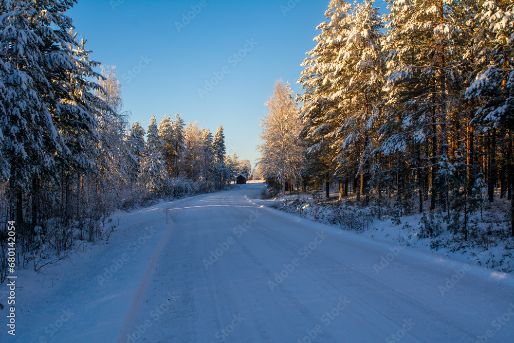 Snowy winter road with trees. Winter conditions in the North. Copy Space
