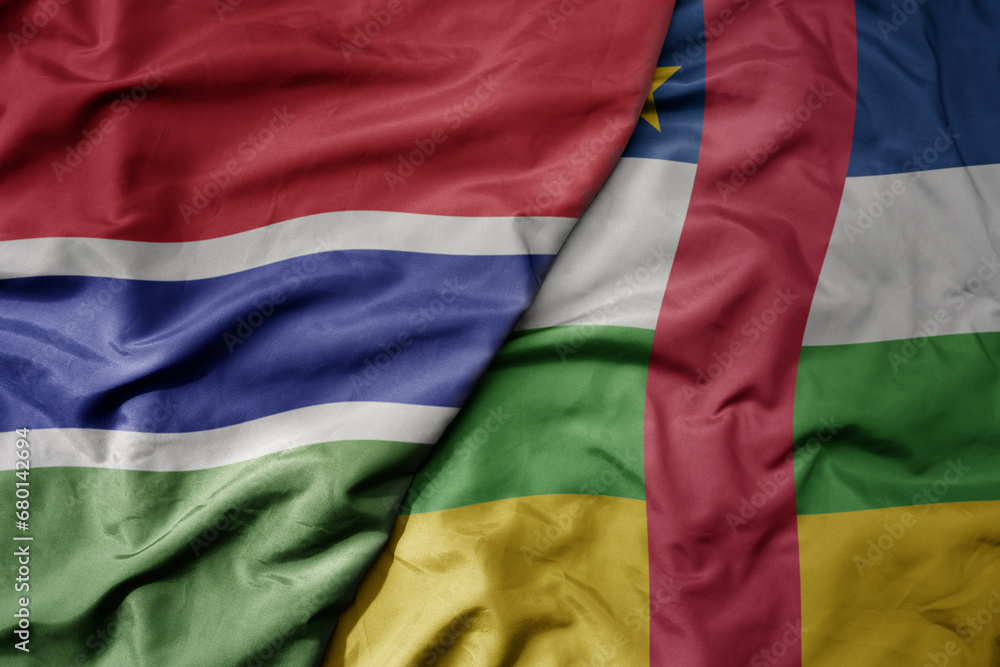 Obraz premium big waving national colorful flag of central african republic and national flag of gambia .
