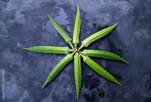 Fresh organic vegetables Lady's Finger or Okra on the Dark concrete floor photo