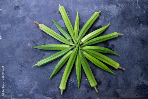 Fresh organic vegetables Lady's Finger or Okra on the Dark concrete floor photo