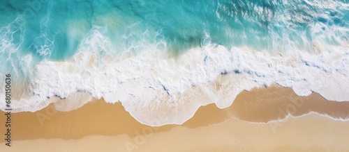 Top down aerial view of turquoise color sea water and golden beach