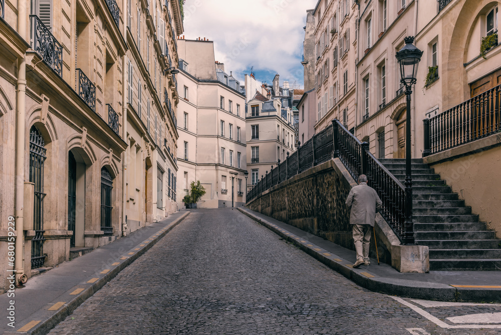 An old gentleman walking on a neighborhood in Montparnasse in Paris