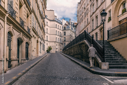 An old gentleman walking on a neighborhood in Montparnasse in Paris © gdefilip
