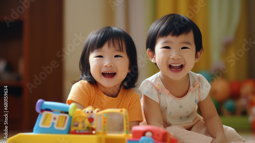 Young Asian children play with toys in the room joyfully, smiles and laughter filling the air, the happiness and fun of childhood.