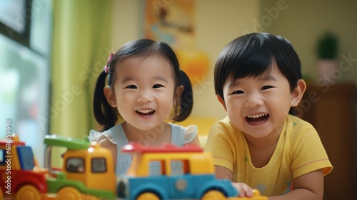 Young Asian children play with toys in the room joyfully, smiles and laughter filling the air, the happiness and fun of childhood.