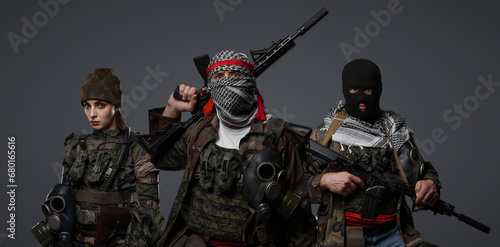 Tableau sur toile Trio of radical extremists from the Middle East in camo attire, keffiyeh, and ba