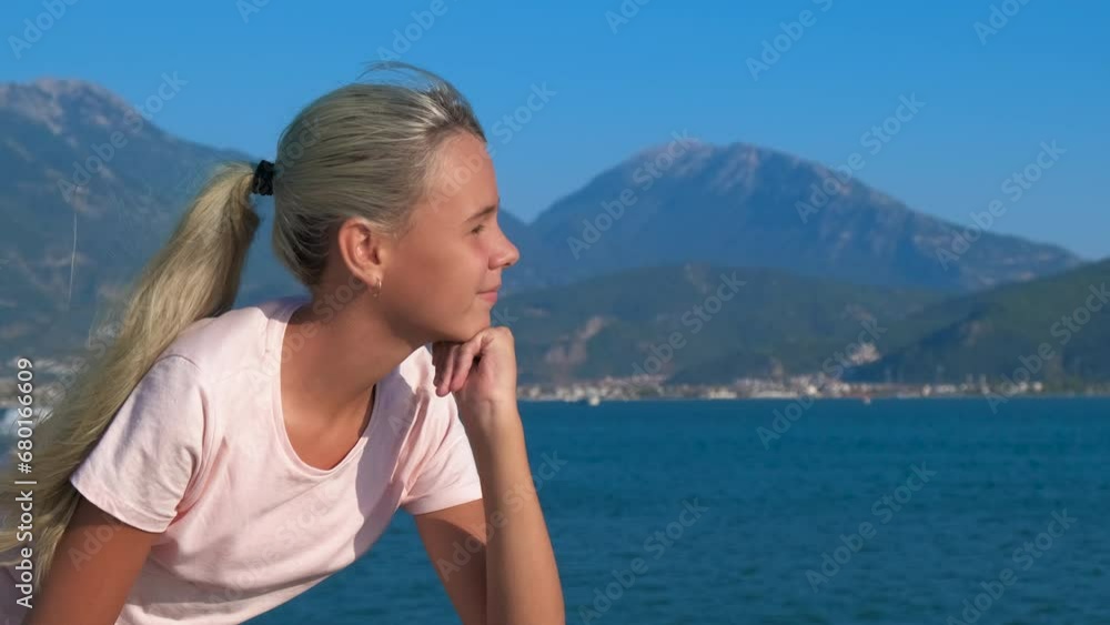 Attractive teen on wooden pier. A view of pensive active teen girl stand in loneliness on the sunny wooden pier in summer. Attractive teen on wooden pier. A view of pensive active teen girl stand in loneliness on the sunny wooden pier in summer.