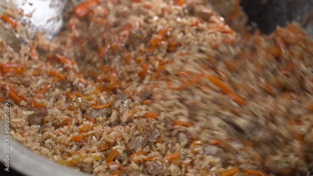 Pilaf is a traditional dish of East Asia. It is cooked in a cauldron on an open fire. Pilaf is a traditional dish of East Asia. It is cooked in a cauldron on an open fire.