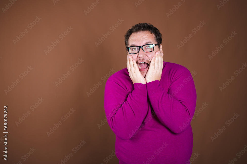 Funny fat man posing in studio on brown background. Different emotions. Funny fat man posing in studio on brown background. Different emotions.