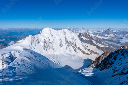 Monte Rosa, landscape of alpine glacier and Dufourspitze highest mount in swiss Alps at SWITZERLAND, from Gornergrat near Zermatt village, cloudy blue sky in 2023 warm sunny summer day, Europe on July