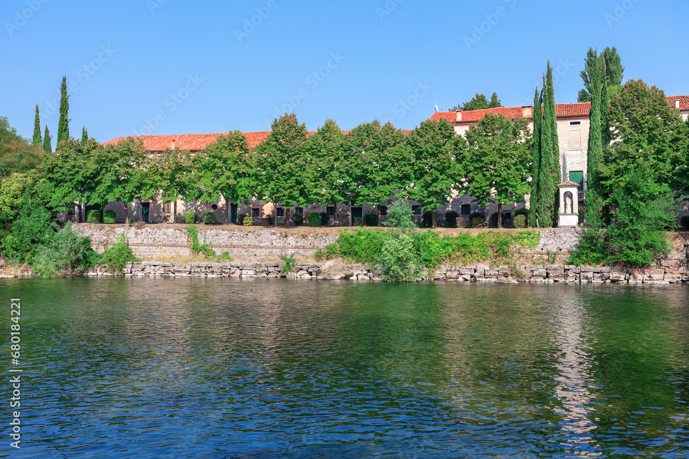 Obraz premium View of Brenta river in Bassano del Grappa , Italy . Scenic landscape of charming riverside