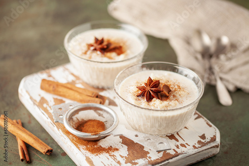 Spanish rice pudding Arroz con Leche in glass cream bowl on the table photo