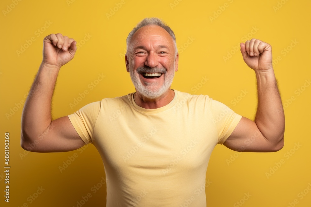 Portrait of a joyful man in his 50s showing off a lightweight base layer against a pastel yellow background. AI Generation Portrait of a joyful man in his 50s showing off a lightweight base layer against a pastel yellow background. AI Generation