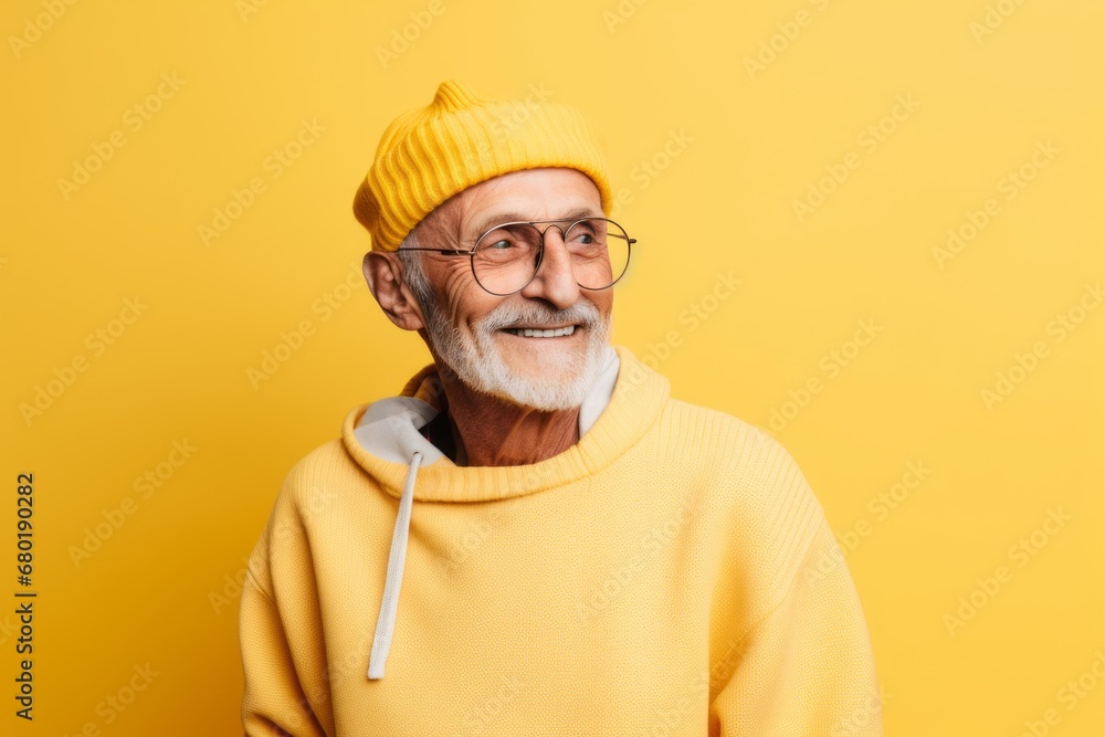 Portrait of a tender man in his 70s sporting a trendy beanie against a pastel yellow background. AI Generation Portrait of a tender man in his 70s sporting a trendy beanie against a pastel yellow background. AI Generation
