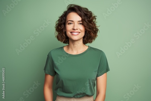 Portrait of a jovial woman in her 30s sporting a vintage band t-shirt against a soft green background. AI Generation © CogniLens