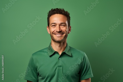 Portrait of a smiling man in his 30s wearing a breathable golf polo against a soft green background. AI Generation