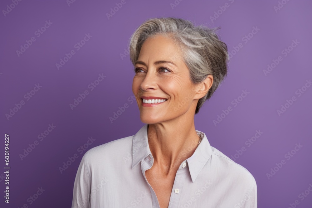 Portrait of a glad woman in her 50s wearing a simple cotton shirt against a soft purple background. AI Generation