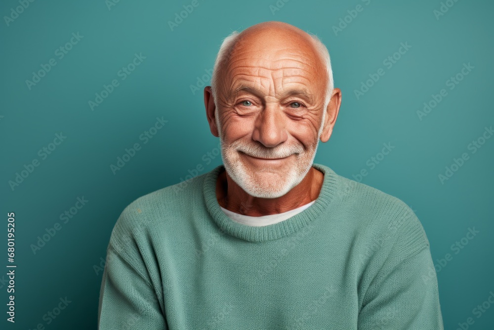 Portrait of a grinning man in his 70s dressed in a comfy fleece pullover against a soft teal background. AI Generation Portrait of a grinning man in his 70s dressed in a comfy fleece pullover against a soft teal background. AI Generation