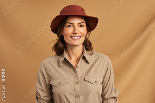 Portrait of a tender woman in her 30s sporting a breathable hiking shirt against a soft brown background. AI Generation