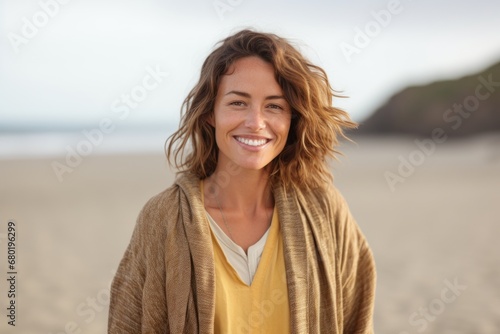 Portrait of a joyful woman in her 30s wearing a chic cardigan against a sandy beach background. AI Generation © CogniLens