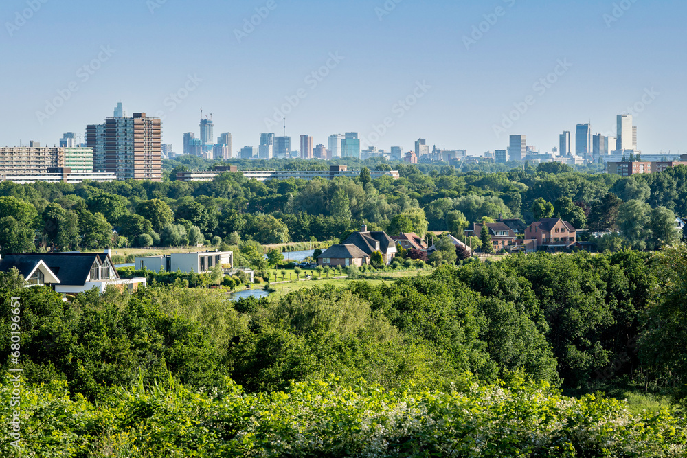 Skyline of Rotterdam with Rotte river and Hoge Bergse Bos recreational area in the foreground
