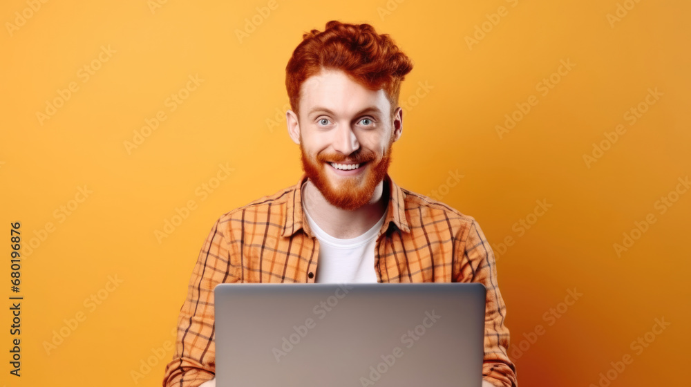 Smiling cheerful smart young ginger man wearing casual teenage clothes using laptop computer pose looking at camera isolated color background - obrazy, fototapety, plakaty 