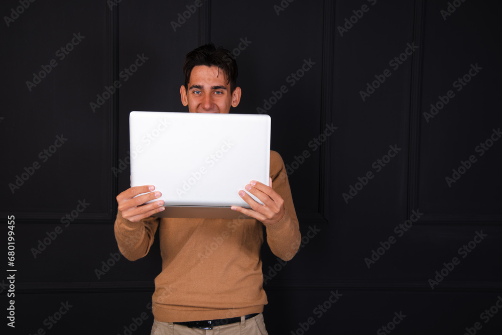 Young attractive student posing with a laptop. Young attractive student posing with a laptop.