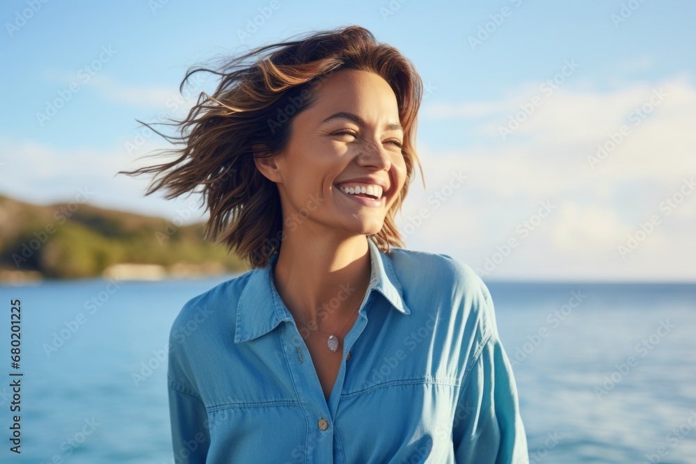 Portrait of a joyful woman in her 30s sporting a versatile denim shirt against a beautiful lagoon background. AI Generation Portrait of a joyful woman in her 30s sporting a versatile denim shirt against a beautiful lagoon background. AI Generation