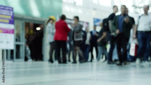 The movements of many business people passing through the business center.