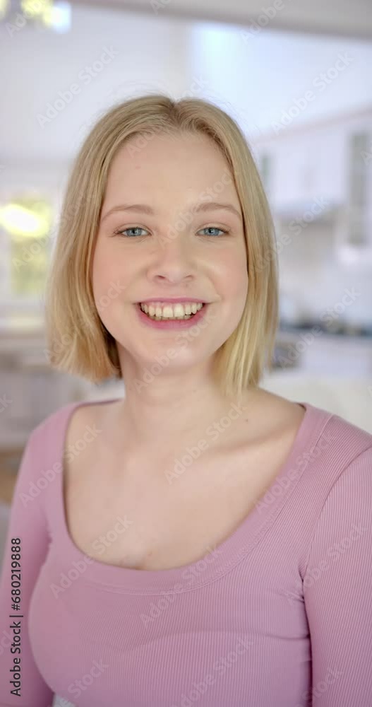 Vertical video of portrait of caucasian female teenager with blond hair at home, slow motion Vertical video of portrait of caucasian female teenager with blond hair at home, slow motion