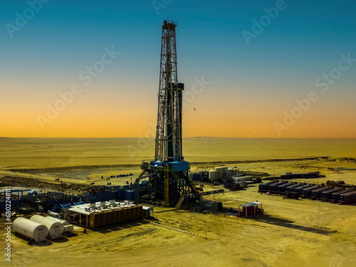 Oil drilling rig at sunset in the Saudi Arabia photo