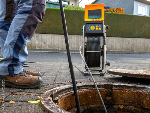 A drain cleaning company checks a blocked drain with a camera before flushing it out
