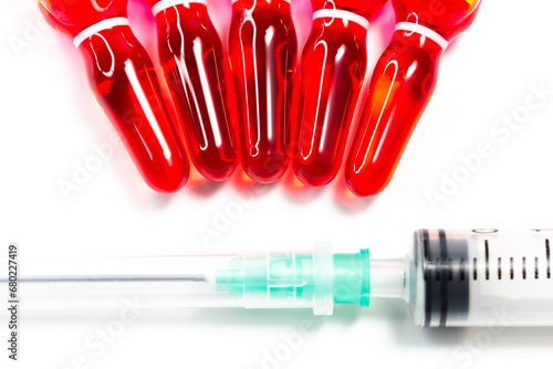 B12 hormone injection ampoules in selective focus. Ampoules and syringes containing solution for injection used for vitamin B12 supplementation. Contains cyanocobalamin. photo