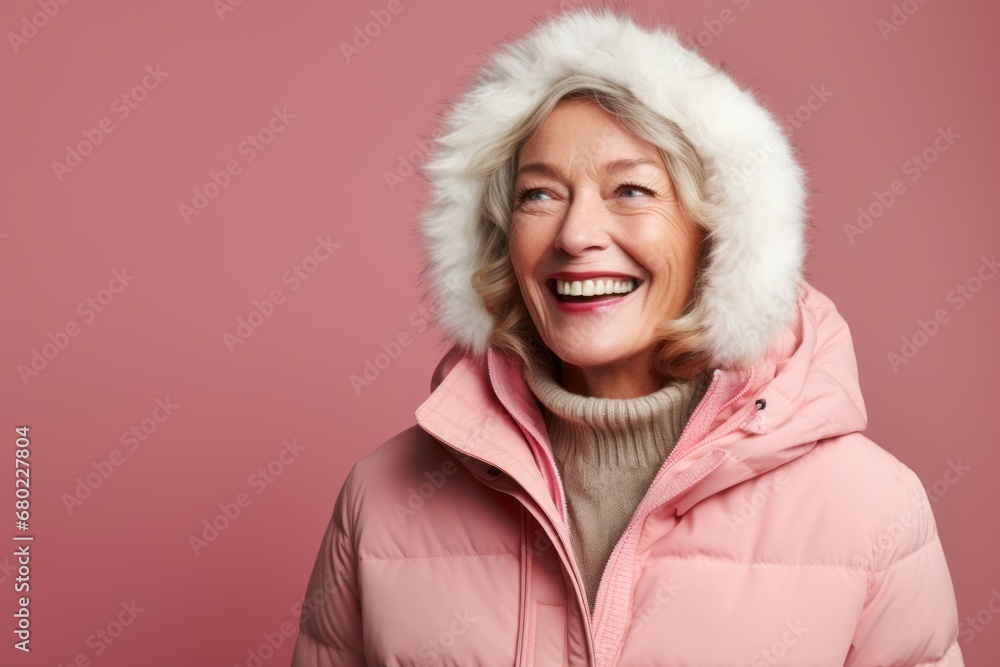 Portrait of a happy woman in her 60s wearing a warm parka against a solid color backdrop. AI Generation Portrait of a happy woman in her 60s wearing a warm parka against a solid color backdrop. AI Generation