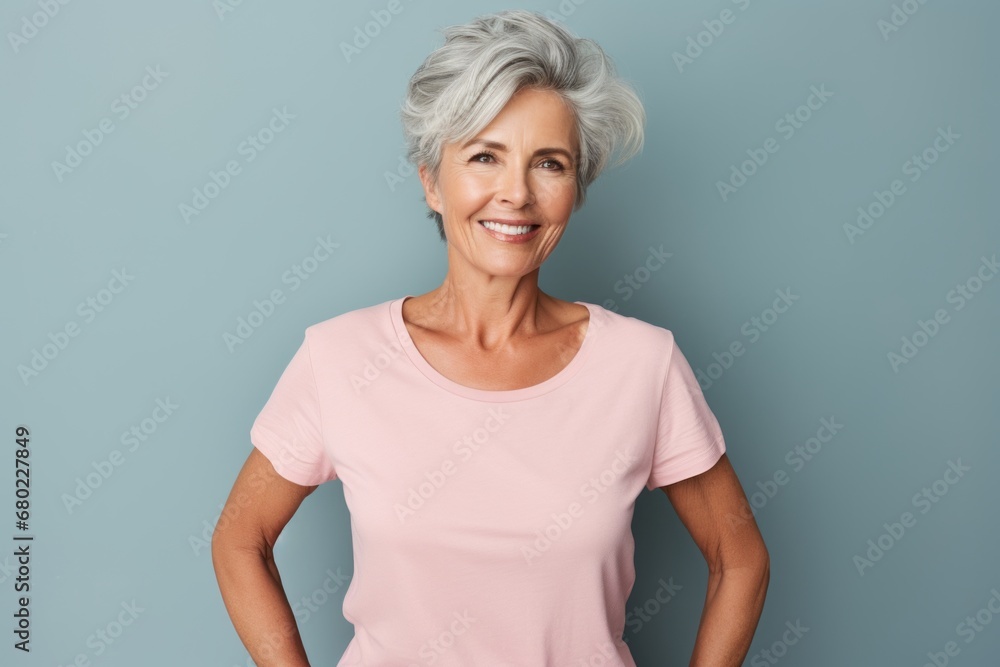 Portrait of a content woman in her 60s dressed in a casual t-shirt against a solid color backdrop. AI Generation Portrait of a content woman in her 60s dressed in a casual t-shirt against a solid color backdrop. AI Generation