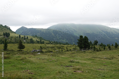 Wide angle landscape view on foggy mountains against a grey sky in the Carpathian alps, Austria